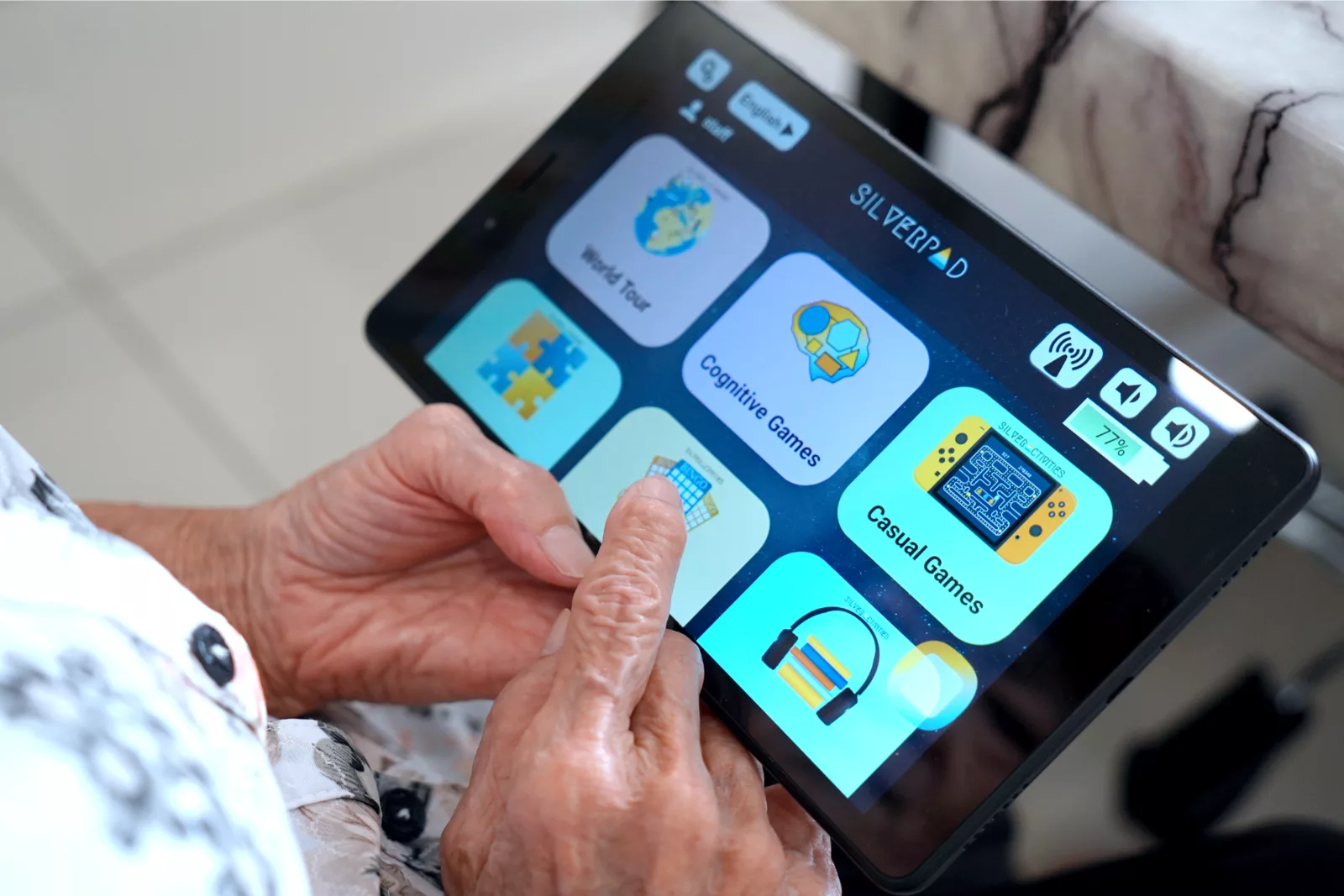 A senior tapping the Bingo tile on a SilverPad home screen